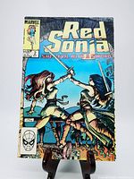 Front cover of Red Sonja #2 comic book from October 1983 showing action scene with two female swordswomen and Marvel Comics branding.