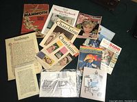 Photo showing assortment of vintage magazines including Chatelaine, Family Circle, Star Diana, Eaton's catalogues, and printed items like Mammoth Scrapbook, Desiderata pages.