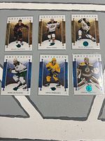 Front side of six Artifacts series hockey cards with images and player names.
