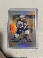 Front of 2022 Upper Deck SP Rookie Alex Newhook hockey card showing holographic foil design, player photo in Colorado Avalanche jersey #18, Upper Deck SP logo.