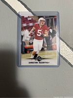 Front image of the Leaf rookie card showing Christian McCaffrey in football gear with ball.