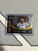 Front of the 2022 Wild Card Ocular Johnny Juzang basketball card with colorful spiral design and player image