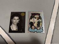 Front of two 1993 Premier Sports Manon Rheaume hockey cards. Left card in black-and-white portrait, right card holographic goalie image.