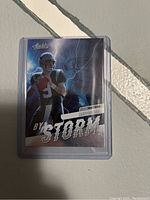 Front view of the Matt Corral Absolute Football 2022 "By Storm" trading card in protective plastic sleeve showing artwork and design.