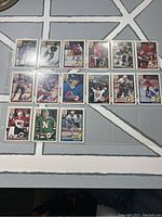 Top view of 15 O-Pee-Chee Top Prospect hockey cards arranged in three rows on a gray and white patterned surface.