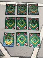 Photo shows front sides of nine World Series motion trivia cards with colorful diamond pattern and years 1911, 1924, 1951, 1959, 1964, and 1991.