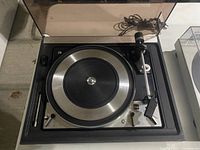 Top view of the Dual 1218 turntable with dust cover open, showing the platter, tonearm and controls.
