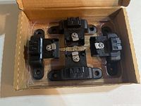 Five black BoxLink tie down cleats with integrated locks mounted in original cardboard packaging.