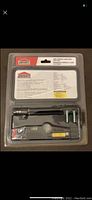 Front view of the Jobmate mini torpedo laser level in sealed blister pack including batteries and instructions on backing card.