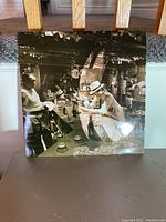 Front sleeve of the Portuguese pressing of Led Zeppelin's "In Through The Out Door" showing a sepia-toned bar scene with patrons.