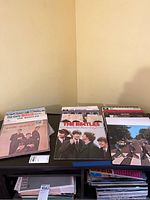Multiple front-facing Beatles LP covers including The Early Beatles, Rock ’n’ Roll Music Vol. 2, Abbey Road and others