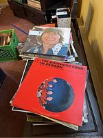 Stack of assorted vintage vinyl albums including The Brothers Four and John Lennon albums.