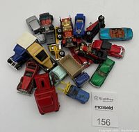 Top-down view showing all 18 diecast vehicles including cars and trucks, showcasing colors and overall lot size
