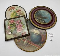 Four vintage chimney flue covers displayed together showing variety of shapes and designs including floral and animal motifs.