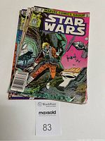 Five Star Wars comics stacked, featuring colorful covers with Luke Skywalker and space battles, showing the dated Marvel Comics Group branding and pricing at 60 cents.