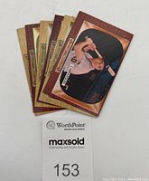 Six vintage mid-1950s Bowman MLB baseball cards fanned out showing front designs with wood veneer style borders and player images in batting stances.