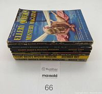 Stack of seven vintage Ellery Queen's Mystery Magazines with visible spines showing volume and issue numbers from 1949 to 1967.