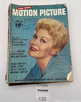 Front cover photo of Motion Picture Magazine October 1956 with a blonde actress on cover, shows worn edges, creases and handwritten notes on cover.