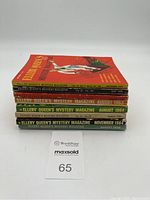 Stack of eight Ellery Queen's Mystery Magazine issues with visible dates and volume numbers.