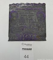 Front image of the rectangular metal printing stamp showing overall condition and size reference.