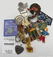 Overall lot collection showing various unique small women's accessories including pins, pendants, and handmade holiday art pieces on a white background.