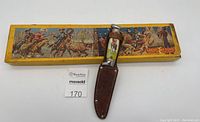 RCMP fixed blade knife with leather sheath and Western illustrated Crescent Toys box