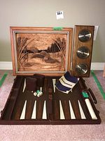 Backgammon game open with dice, instructions, leather case, carved wooden art, and wooden barometer with three dials.