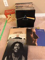 Photo of assorted vinyl album covers including Pink Floyd, Carpenters, Bob Marley, Soul Train, and Cher.