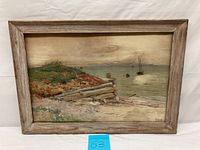 Full view of watercolor seascape painting in rustic wood frame showing coastal scene with boats and wooden pier structure.
