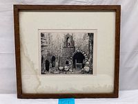 Front view of framed etching depicting a shrine with wooden frame and matting showing water stains