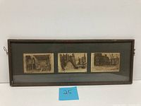 Photo of the framed set of three historical building etchings mounted horizontally