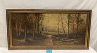 Frontal view of oil painting showing wooded road and fence in ornamental frame.