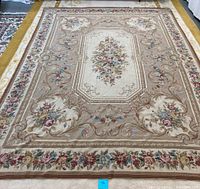 Full view of the vintage French Aubusson area rug showing floral medallion and scrollwork design.