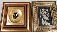 View of two framed bird artworks side by side on a surface, showing their contrasting designs and frames.
