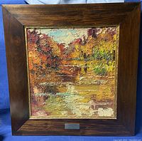 Full front view of the framed oil painting showing the textured autumnal landscape scene and broad wood frame.