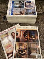 Stack of ten Architectural Digest magazines with visible covers showing home decor and design themes, dated from the 1990s to 2001.