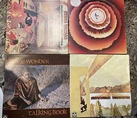 Four vintage Stevie Wonder vinyl albums displayed: Fulfillingness' First Finale, Songs in the Key of Life, Innervisions, and Talking Book, showing original cover art.