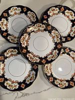 Five plates arranged in a circular pattern had a rich blue and gold floral design