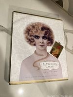 Front cover of the hardcover book 'Marchesa Casati: Portrait of a Muse' with original dust jacket featuring a portrait of a woman with curly hair and jewelry.