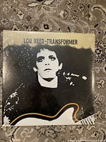 Front cover of Lou Reed Transformer album showing Lou Reed's image and album title with visible original shrink wrap.