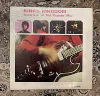 Front cover of the Kinks Kingdom vinyl album showing band member images and guitar close-up.