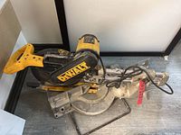 Overall view of DeWalt DW708 12-inch sliding compound miter saw showing base, sliding rails, and blade guard