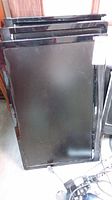 Three black flat panel monitors stacked vertically, showing size and model lines on the side edges.