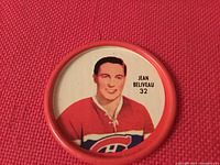 Front view of 1962-63 Shirriff hockey coin featuring Jean Beliveau in Montreal Canadiens jersey number 32, red border.