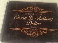Front of the commemorative display folder with decorative text and 'Last Year of Issue Susan B Anthony Dollar 1999'