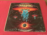 Front cover of Vintage Boston LP album showing sci-fi spaceship artwork with significant age wear and edge damage.