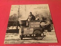 Front cover of Pretzel Logic album showing hot pretzel cart and street vendor in black and white photo