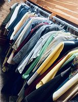 Full rack of women's suit jackets and blazers in various colors and fabrics