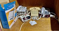 Photo of multiple telephones including an AT&T model with box and cords