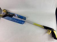 Full length view of one grabber showing overall length, head and handle.